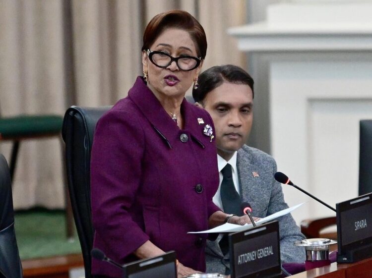 fighting against crime: Prime Minister Kamla Persad-Bissessar delivers a statement during yesterday’s sitting of Parliament. At right is Public Utilities Minister Barry Padarath. —Photo: JERMAINE CRUICKSHANK