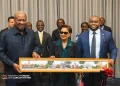 A GIFT: Prime Minister Kamla Persad-Bissessar, centre, and Foreign Affairs Minister Sean Sobers, right, present a painting of the Magnificent Seven to John Dramani Mahama, President of the Republic of Ghana, before their bilateral meeting in New York, yesterday.