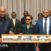 A GIFT: Prime Minister Kamla Persad-Bissessar, centre, and Foreign Affairs Minister Sean Sobers, right, present a painting of the Magnificent Seven to John Dramani Mahama, President of the Republic of Ghana, before their bilateral meeting in New York, yesterday.