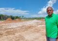 Sherod Duncan MP (APNU) standing in front the site of the proposed Mahdia Housing Developmeent