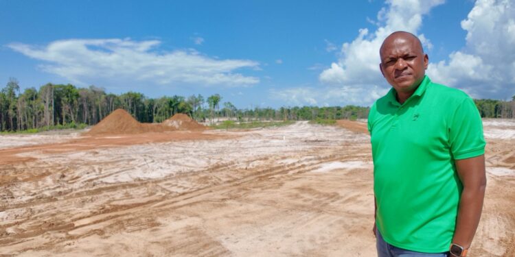 Sherod Duncan MP (APNU) standing in front the site of the proposed Mahdia Housing Developmeent