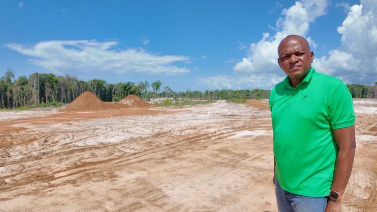 Sherod Duncan MP (APNU) standing in front the site of the proposed Mahdia Housing Developmeent