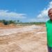 Sherod Duncan MP (APNU) standing in front the site of the proposed Mahdia Housing Developmeent