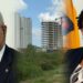L-R Minister Juan Edgehill and Frm Minister Annette Ferguson (background- incomplete Govt offices complex)