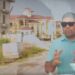 Opposition Leader Azruddin Mohamed standing in front of Mustapha's property