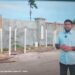 Opposition Leader Azruddin Mohamed standing in front of the wall at Leonora, West Coast Demerara (screen grab photo)