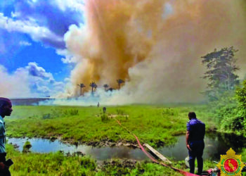 GDF helicopter conducts aerial water drops over the savannah fire near Moblissa Ranch along the Soesdyke-Linden Highway
