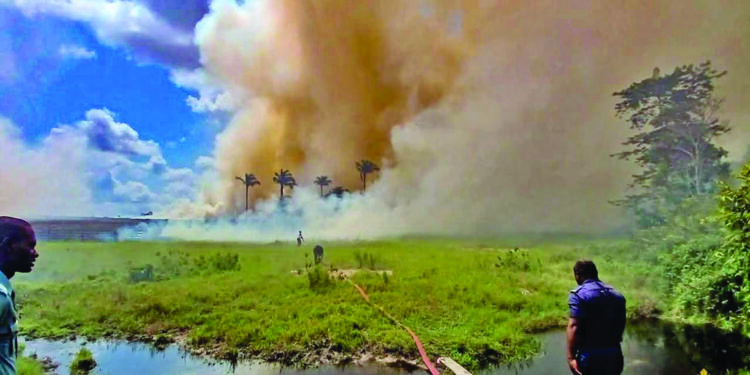 GDF helicopter conducts aerial water drops over the savannah fire near Moblissa Ranch along the Soesdyke-Linden Highway