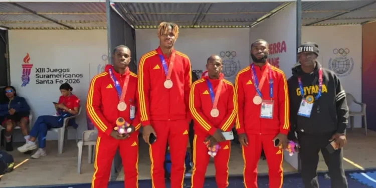 4x100m team: Onesi Dunn, Revon Williams, Akeem Stewart, and Shamar Horatio along with coach Mark Scott