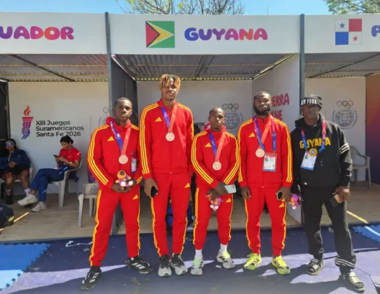 4x100m team: Onesi Dunn, Revon Williams, Akeem Stewart, and Shamar Horatio along with coach Mark Scott