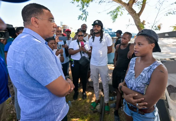 Photo: YHOMO HUTCHINSON
Prime Minister, Dr. the Most Hon. Andrew Holness (left) engages with residents of the Cooper's Pen community in Trelawny on Friday (August 28).