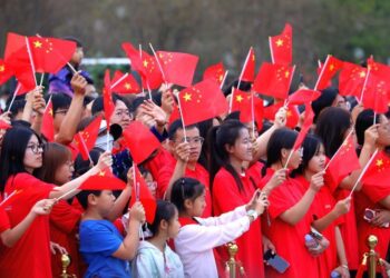 People watch a performance after attending a flag-raising ceremony at Dongfeng Square in Kunming, southwest China's Yunnan Province, Oct. 1, 2026. (Photo by Zheng Yi/Xinhua)