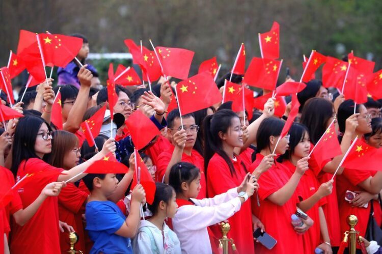 People watch a performance after attending a flag-raising ceremony at Dongfeng Square in Kunming, southwest China's Yunnan Province, Oct. 1, 2026. (Photo by Zheng Yi/Xinhua)