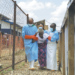 Healthcare workers assist a patient who has been cleared of Ebola at a treatment center in Beni, North Kivu Province, Democratic Republic of the Congo, on Tuesday. SEBASTIEN KITSA MUSAYI/AP