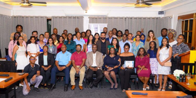 Professor Temitope Oyedotun, Guyana-PROMAR Project Lead and lecturer in the University of Guyana’s Faculty of Earth and Environmental Sciences; Mr. Amarnath Munnolimath, Head of Green and Circular Economy at adelphi; and Ms. Tracy Phillips of the United Nations Environment Programme (UNEP) Cartagena Convention Secretariat, pose with awardees and attendees at the PROMAR closing ceremony at the Grand Coastal Inn Hotel, East Coast Demerara, on October 14, 2026, marking the conclusion of the project’s implementation phase in Guyana.