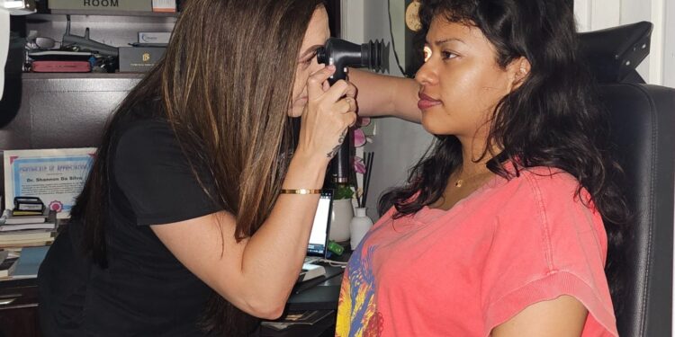 Dr Shannon Da Silva performs an ophthalmoscopy (eye pathology) examination on a patient at her South Road Office.