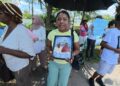MV Barima protest-   Centre - Jasmine holding photos of Neil and Henry Cort who perished in the July 18, 2026 sinking