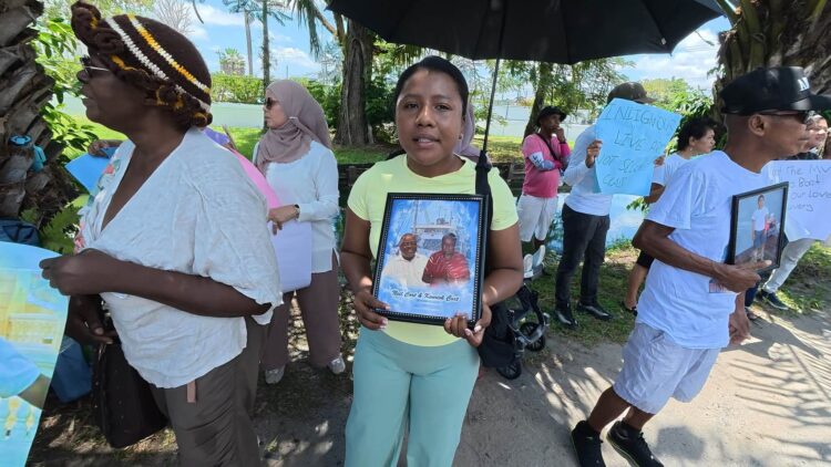 MV Barima protest- Centre - Jasmine holding photos of Neil and Henry Cort who perished in the July 18, 2026 sinking