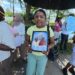 MV Barima protest- Centre - Jasmine holding photos of Neil and Henry Cort who perished in the July 18, 2026 sinking