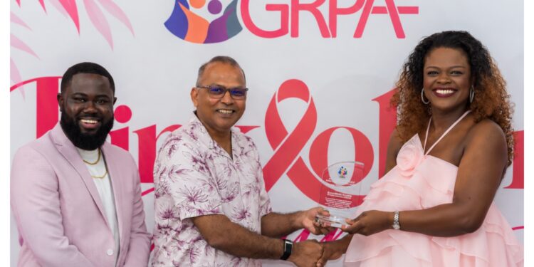 GGI Lead, Alicia Bess-Anderson accepting the award from the Honourable Dr. Frank Anthony, Minister of Health in the presence of Executive Director of the Guyana Responsible Parenthood Association (GRPA), Kobe Smith.