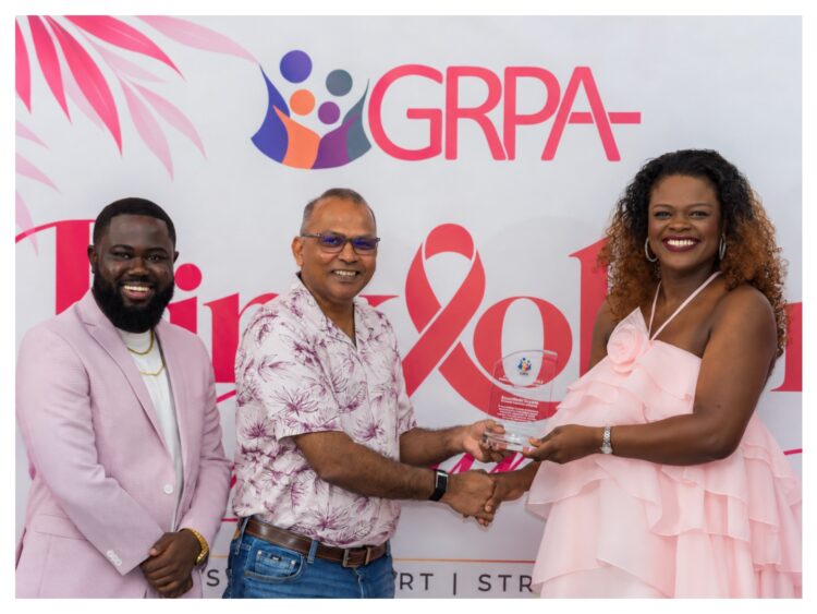 GGI Lead, Alicia Bess-Anderson accepting the award from the Honourable Dr. Frank Anthony, Minister of Health in the presence of Executive Director of the Guyana Responsible Parenthood Association (GRPA), Kobe Smith.