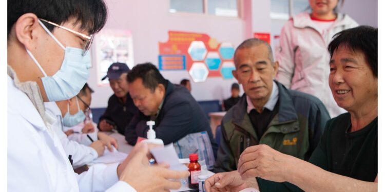 Medical experts provide free medical consultations for elderly people in Guoshan Community, Chengde, north China's Hebei Province, October 14, 2026. /VCG