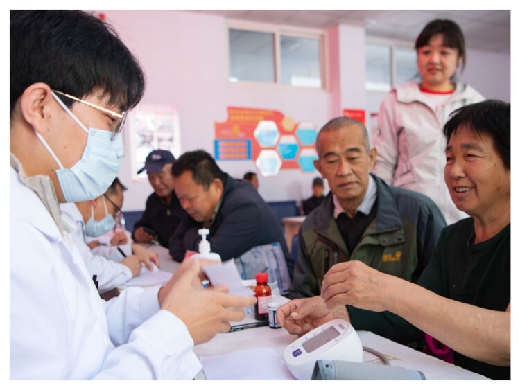 Medical experts provide free medical consultations for elderly people in Guoshan Community, Chengde, north China's Hebei Province, October 14, 2026. /VCG