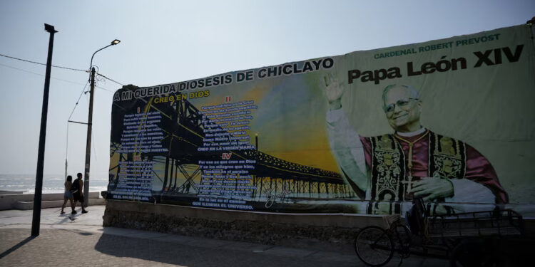 People walk past a mural dedicated to Pope Leo on the oceanfront boardwalk overlooking the Pacific Ocean, as Peruvians remember Pope Leo as a migrant priest who helped feed hungry families, delivered aid after floods and walked alongside refugees during his years in Peru, ahead of his November... Purchase Licensing Rights