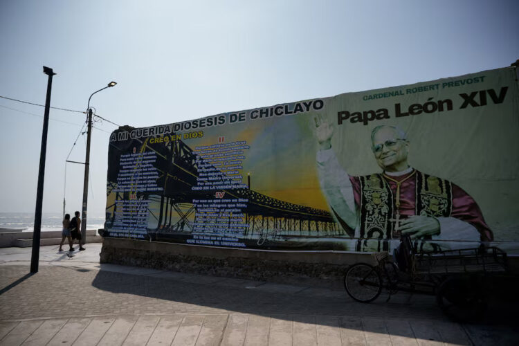 People walk past a mural dedicated to Pope Leo on the oceanfront boardwalk overlooking the Pacific Ocean, as Peruvians remember Pope Leo as a migrant priest who helped feed hungry families, delivered aid after floods and walked alongside refugees during his years in Peru, ahead of his November... Purchase Licensing Rights