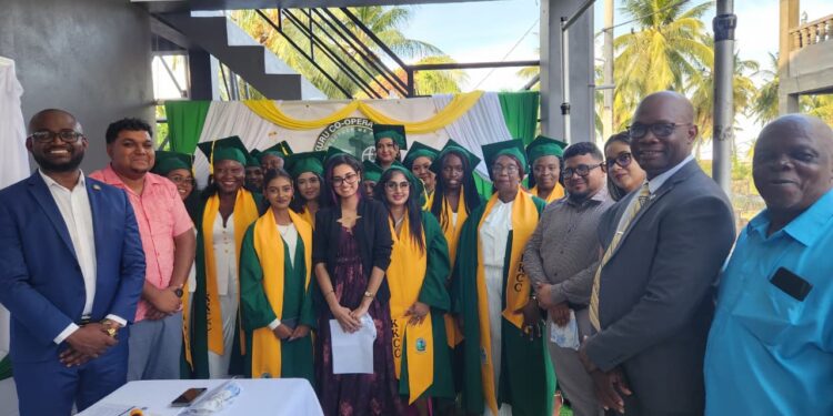 Photo caption: From left, Dr. Kofi Dalrymple and Mahaicony/Abary NDC Vice Chairman Mr. Leon Wordsworth, with the graduates and lecturer Ms. Chandradai Devina Persaud, Regional Chairman Mr. Recardo Phillips, Regional Executive Officer Ms. Mary Samaroo, Mr. Hansen Elliot, Principal of the Kuru Kuru Cooperative College and Mr. Matthews representative of Kuru Kuru College