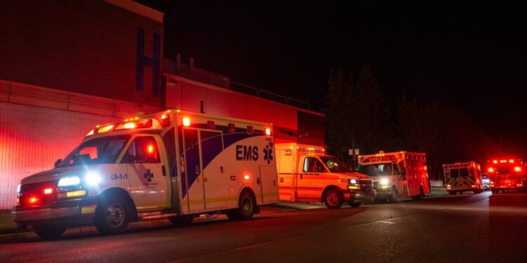 Emergency crews and military personnel gather at the Wainwright Health Centre as injured military members are treated after a fire at Canadian Forces Base Wainwright, outside of Wainwright, Alberta Saturday, Oct. 17, 2026. (John Ulan/The Canadian Press via AP)