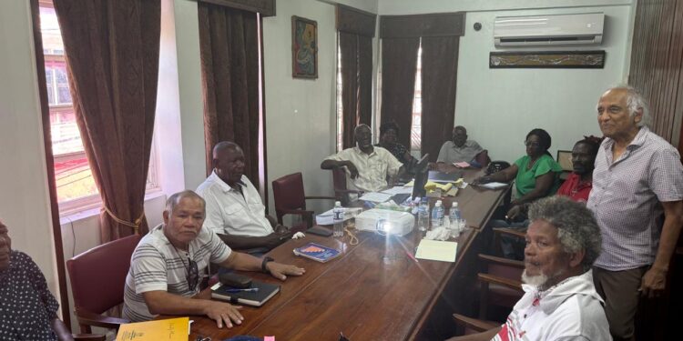 Christopher Ram (standing at right) with union leaders (Kiskadee photo)