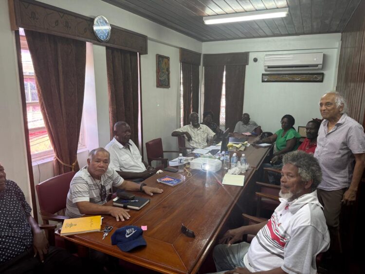 Christopher Ram (standing at right) with union leaders (Kiskadee photo)