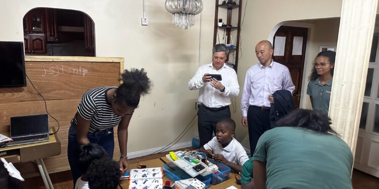 STEMGuyana students demonstrating their skills as MODEC President & CEO, Mr. Hirohiko Miyata and team watch on.(STEMGuyana photo)