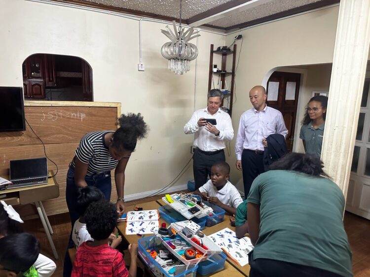 STEMGuyana students demonstrating their skills as MODEC President & CEO, Mr. Hirohiko Miyata and team watch on.(STEMGuyana photo)